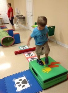 A child playing on gym equipment in Lutz Montessori School and Montessori at Trinity Oaks